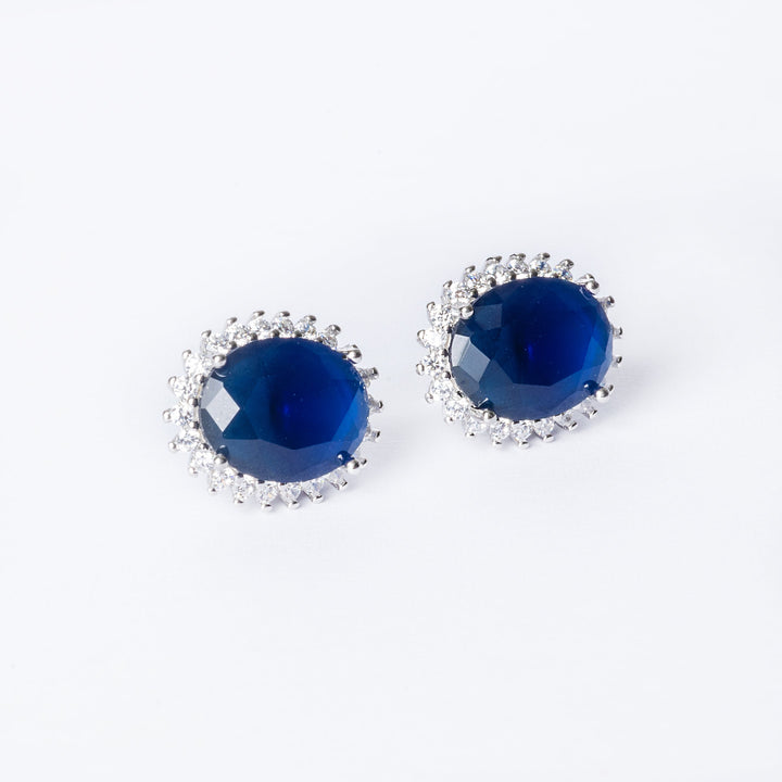A close up view of Kate Earrings in a blue colour standing in the center of the image against a white background.