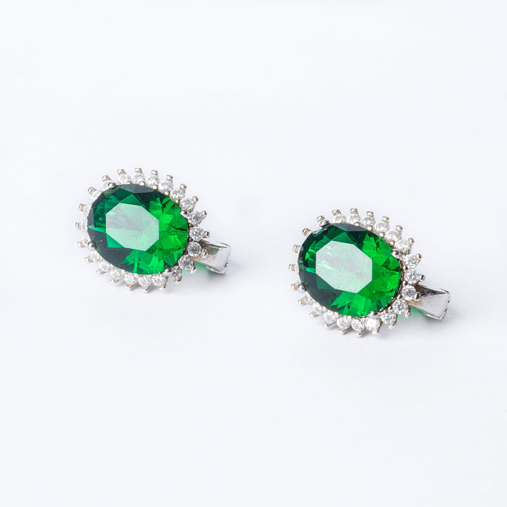 Bird view of Kate Earrings in green colour standing in the center of the image against a white background. 