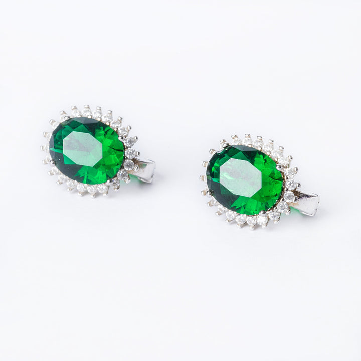A close up view of Kate earrings in green stone colour standing in the center of the image against a white background. 