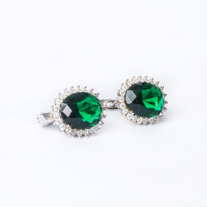 A close up view of Kate Earrings green stone colour standing in the center of the image against a white background. 