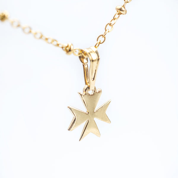 A close up view of Melita Gold Maltese Cross Pendant. 