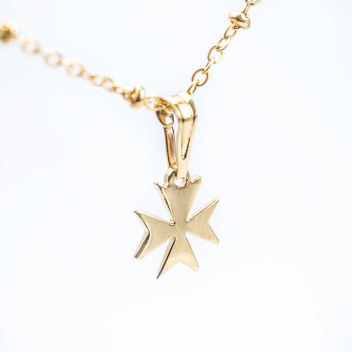 A close up view of Melita Gold Maltese Cross Pendant. 