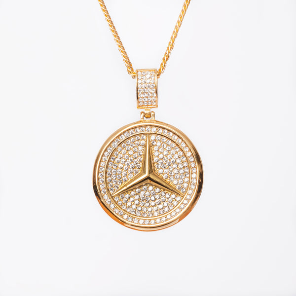 A yellow gold necklace featuring a circular design with a Mercedes-Benz logo encrusted in cubic zirconia, with a chain included.