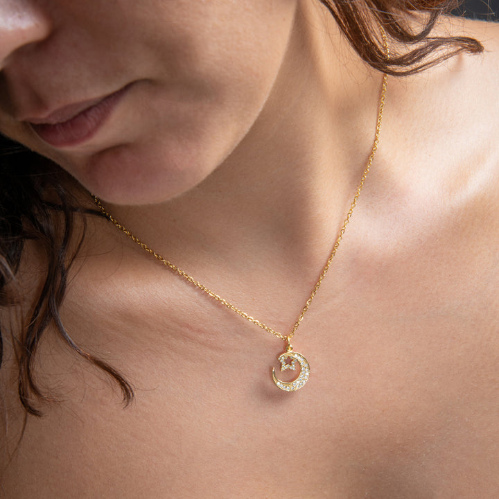 A close up view of Moon & Star Gold Pendant. 