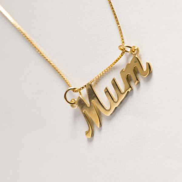 A gold necklace with the inscription 'Mum' in cursive script, displayed against a white background.