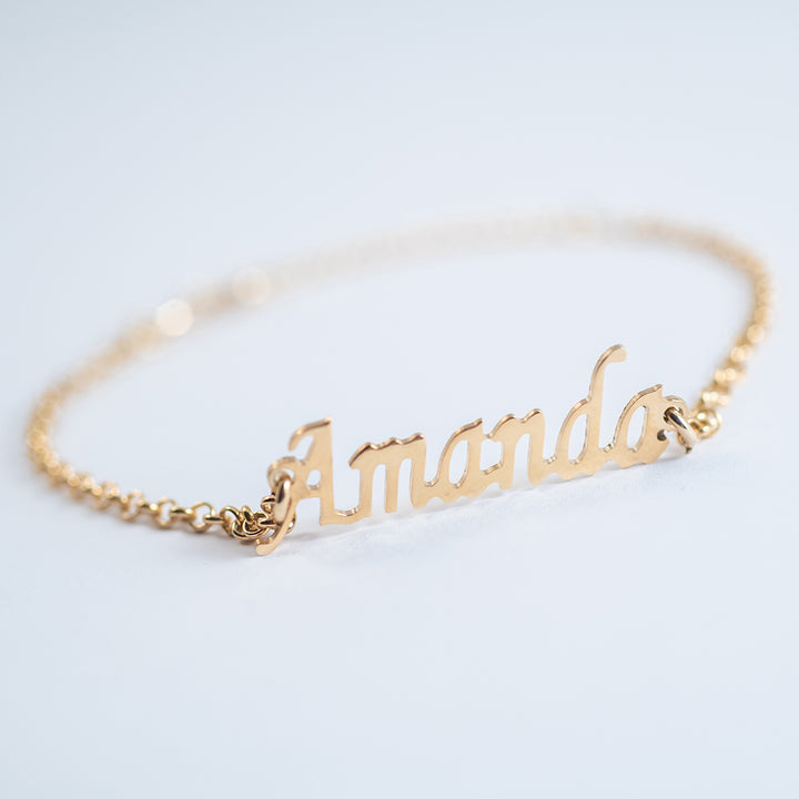 A close up view of Name Bracelet standing in the center of the image against a white background. 