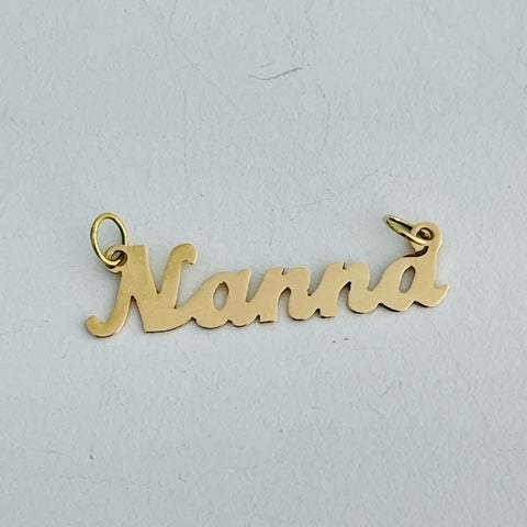 A 18ct gold necklace with the word 'NANN' written in bold letters, displayed against a white background.