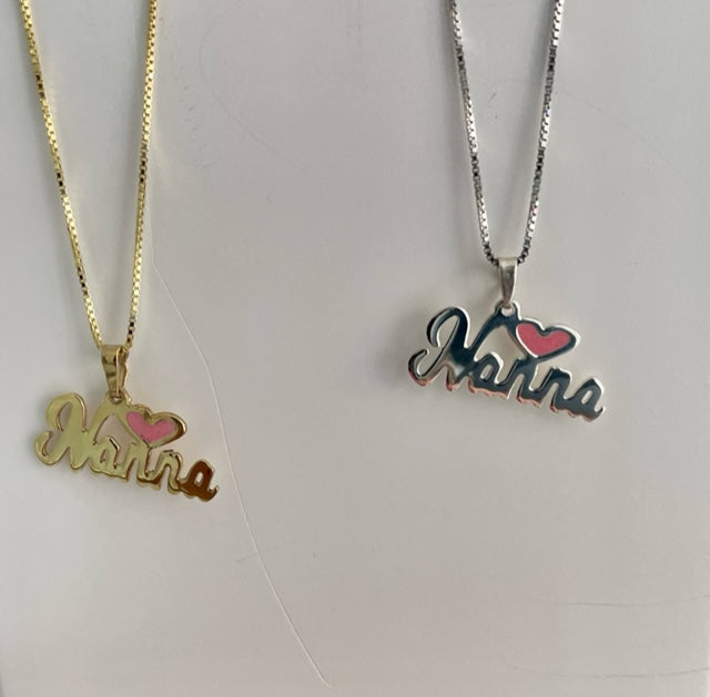 Two nana necklaces, one in gold, other in silver colour standing next to each other.