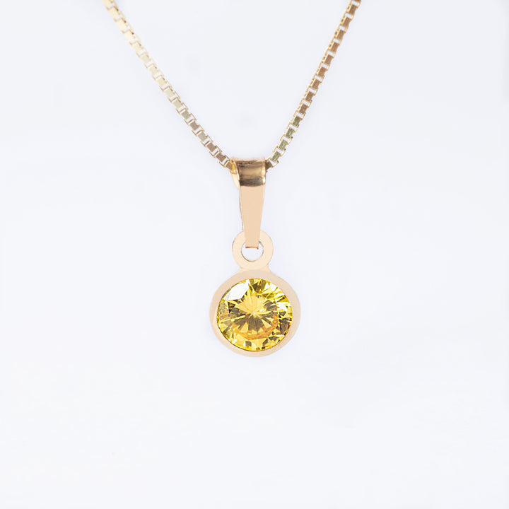 A yellow gold-plated silverNovember Birth Stone pendant with a citrine yellow gemstone in the center, attached to a gold-plated chain.