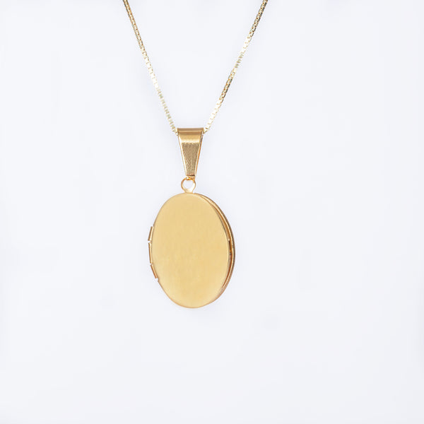 A yellow gold plated oval locket necklace with a chain included, displayed against a white background.