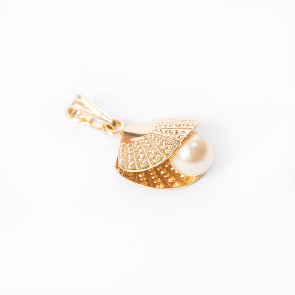 A yellow gold oyster pearl pendant with a chain loop on top, featuring a central pearl surrounded by smaller ones.