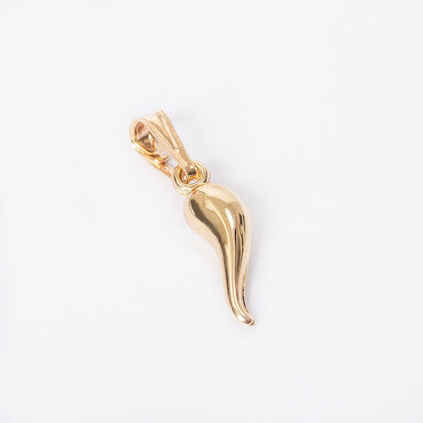 A gold-colored pepper-shaped Pepper pendant on a white background, attached to a small gold chain.