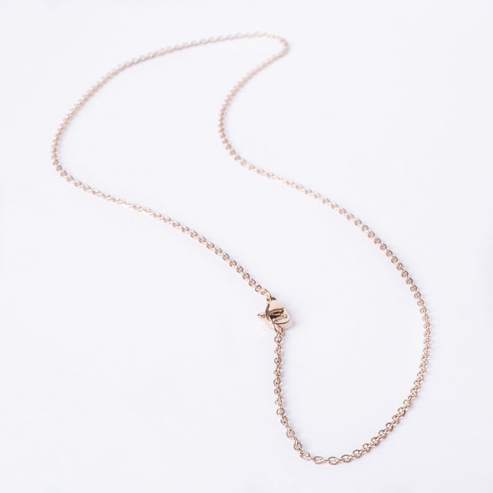 A close up view of gram collections's Rose Gold Chain, standing in the center of the image against a white background. 