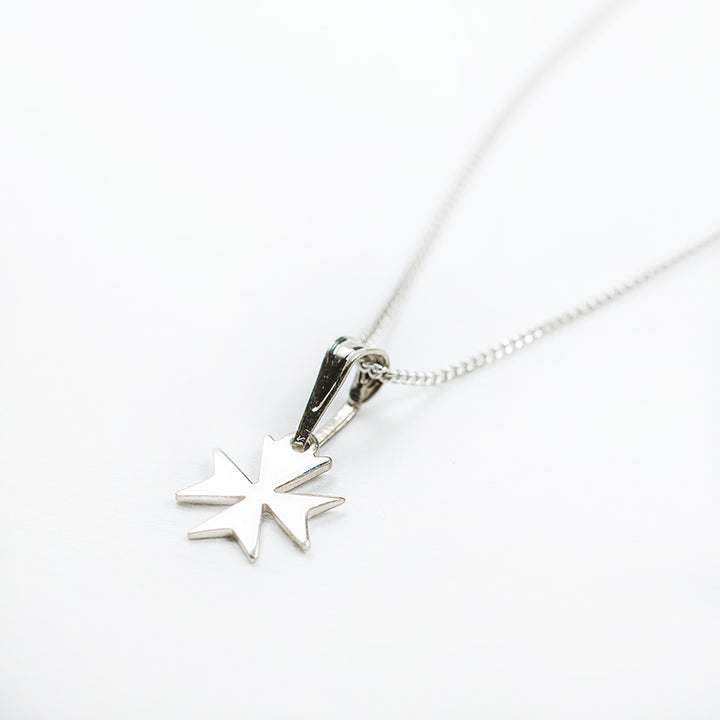 A side view of Melita Maltese Cross Pendant