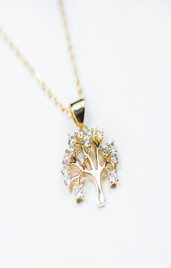 A yellow gold-plated Tree of Life pendant necklace with a silver chain and extension, adorned with cubic zirconia.