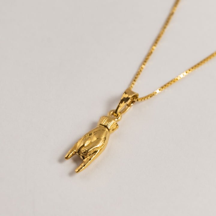 Side view of Qrun Lucky Charm Pendant. 
