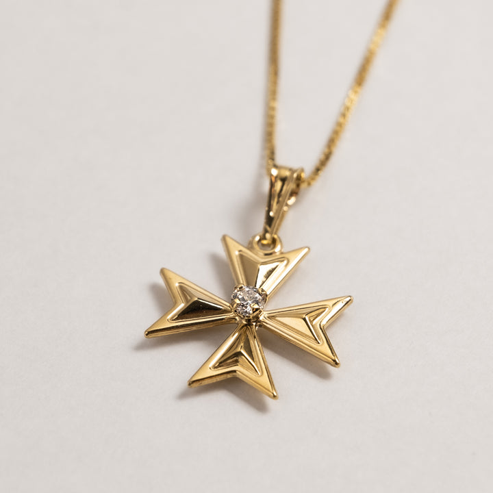 Side view of Valletta Gold Maltese Cross standing in the center of the image against a white background. 