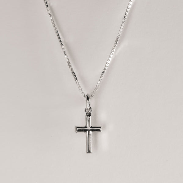 A close up view of Silver Embossed Cross Pendant. 