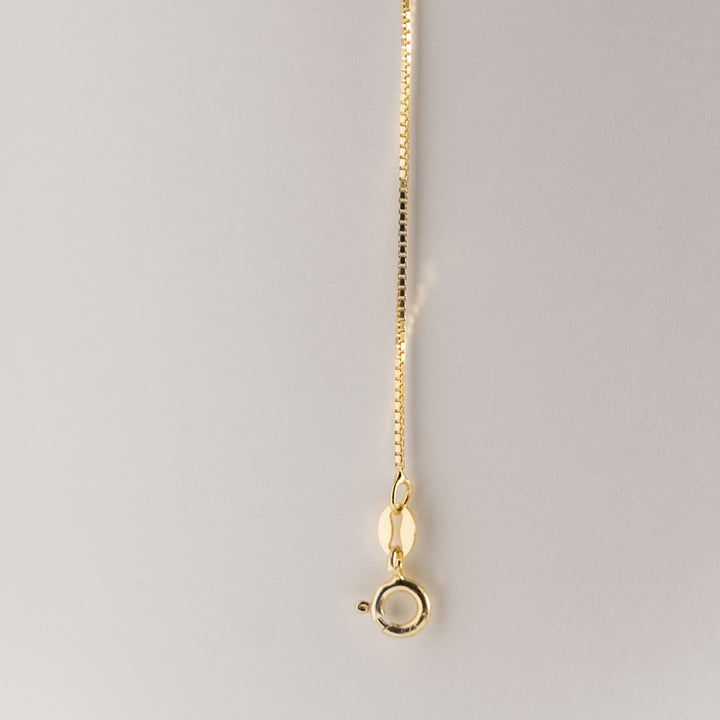 A Silver Yellow Gold Chain standing in the center of the image against a white background. 