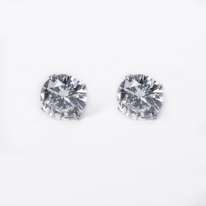A close up view of Solitaire Silver Stud Earrings standing in the center of the image. 