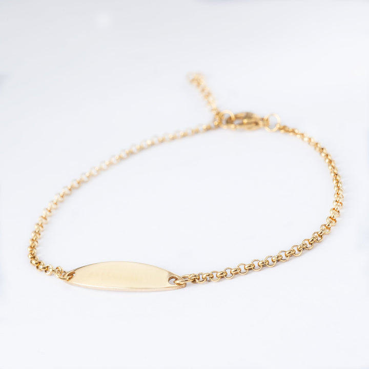 A close up view of Tennis Gold bracelet standing in the center of the image against a white background. 