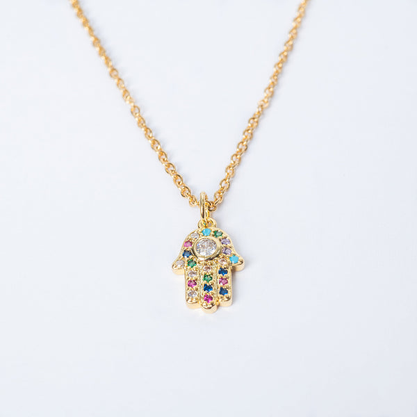 A gold-plated Hamsa necklace with a silver chain, featuring multicolored cubic zirconia in the pendant.