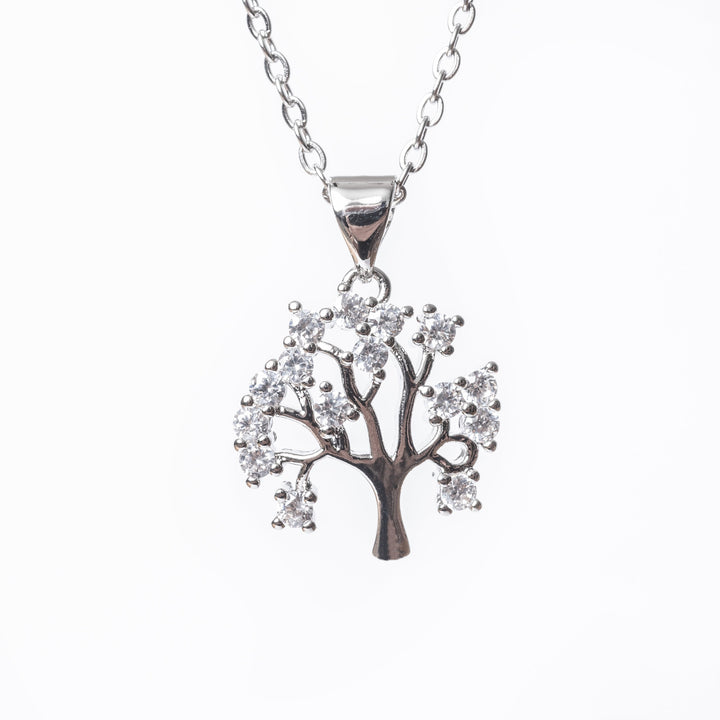 A close up view of Tree Of Life Necklace standing in the center of the image against a white background. 