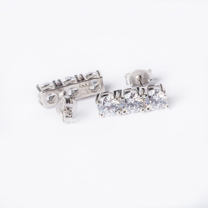 A close up view of Trilogy Earrings - one shown from front side, another from the back. 