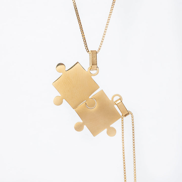 two Puzzle Couple Necklaces standing in the center of tthe image against a white background, 