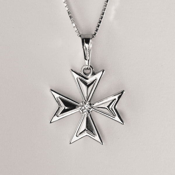 A silver Maltese cross necklace with a central cubic zirconia surrounded by smaller clear crystals on a silver chain.