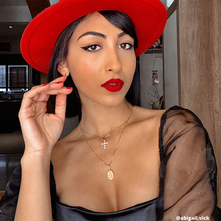 blond woman in her mid 20s wearing holy mary medal double sided pendant. 