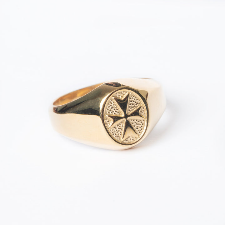 A close up view of Xandru Gold ring standing in the center of the image against a white background. 