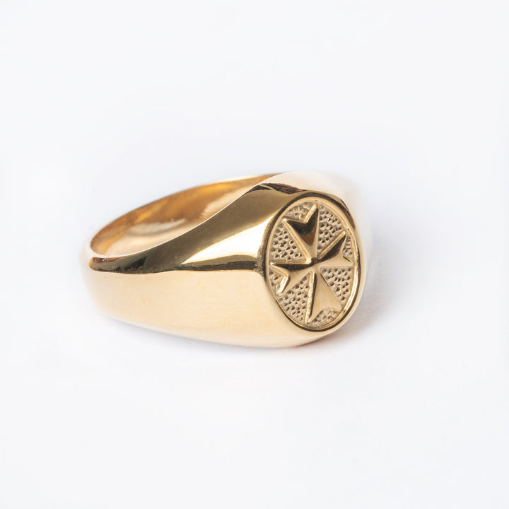A close up right side view of Xandru Gold ring standing in the center of the image against a white background. 