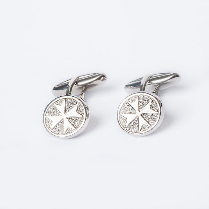 A close up view of Xandru Silver cufflinks standing in the center of the image against a white background. 
