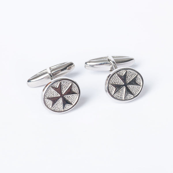 A pair of silver cufflinks with a geometric pattern on the central part.